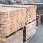 Pallets,and,packages,of,freshly,produced,red,bricks,in,a