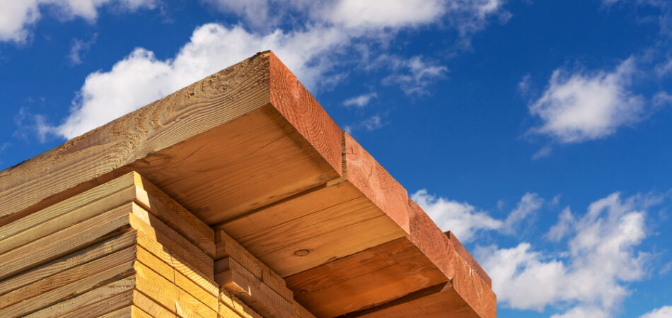 Stack,of,dimensional,lumber,for,home,construction,with,partly,cloudy