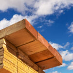 Stack,of,dimensional,lumber,for,home,construction,with,partly,cloudy